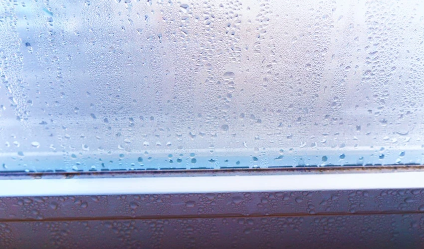 Condensation on a window above its frame