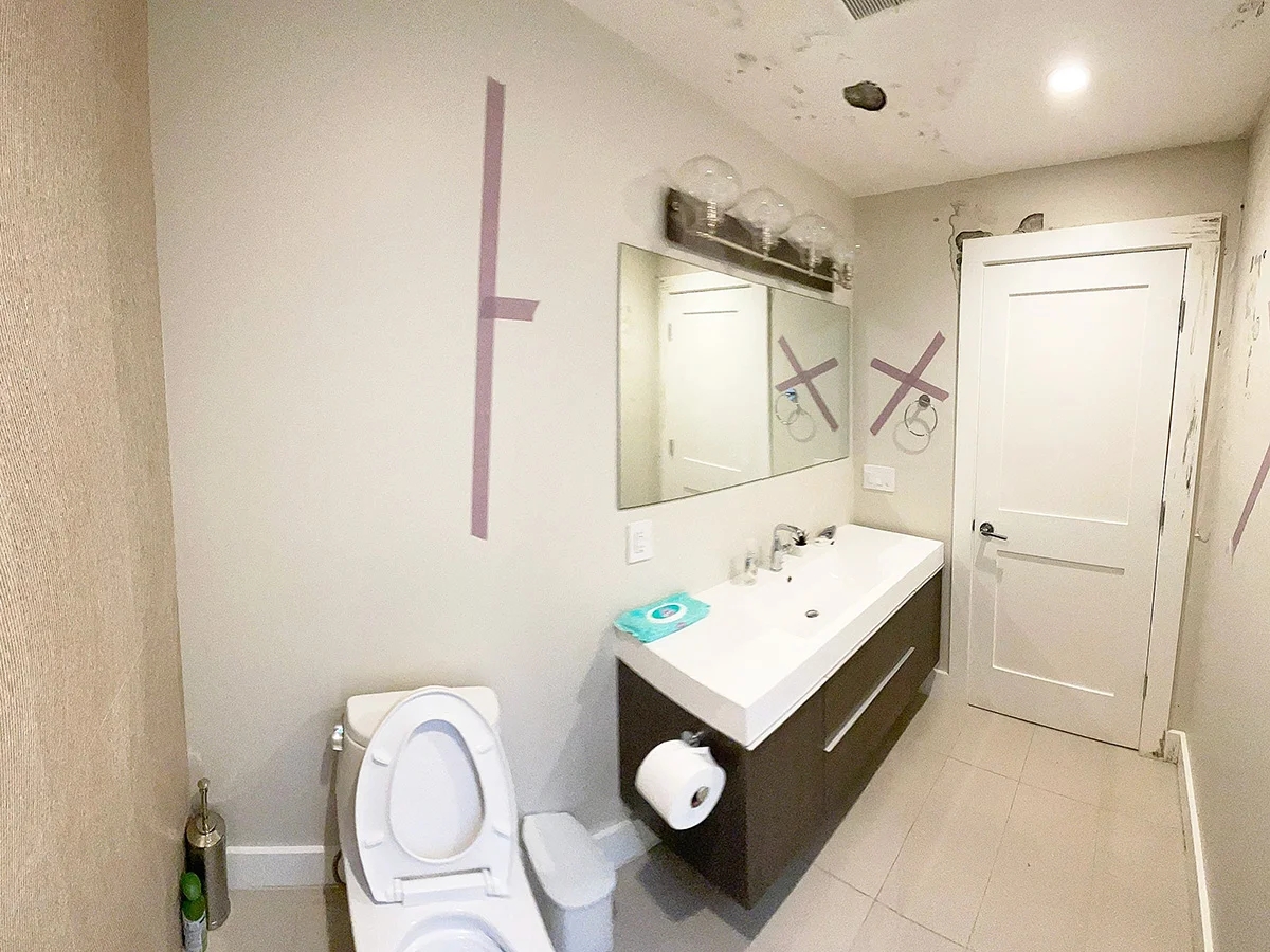 Bathroom wall marked for water damage assessment — San Francisco, CA