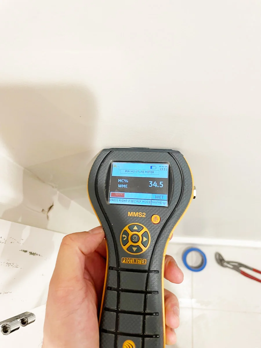 Moisture meter checking the bathroom wall above a vanity — San Francisco, CA