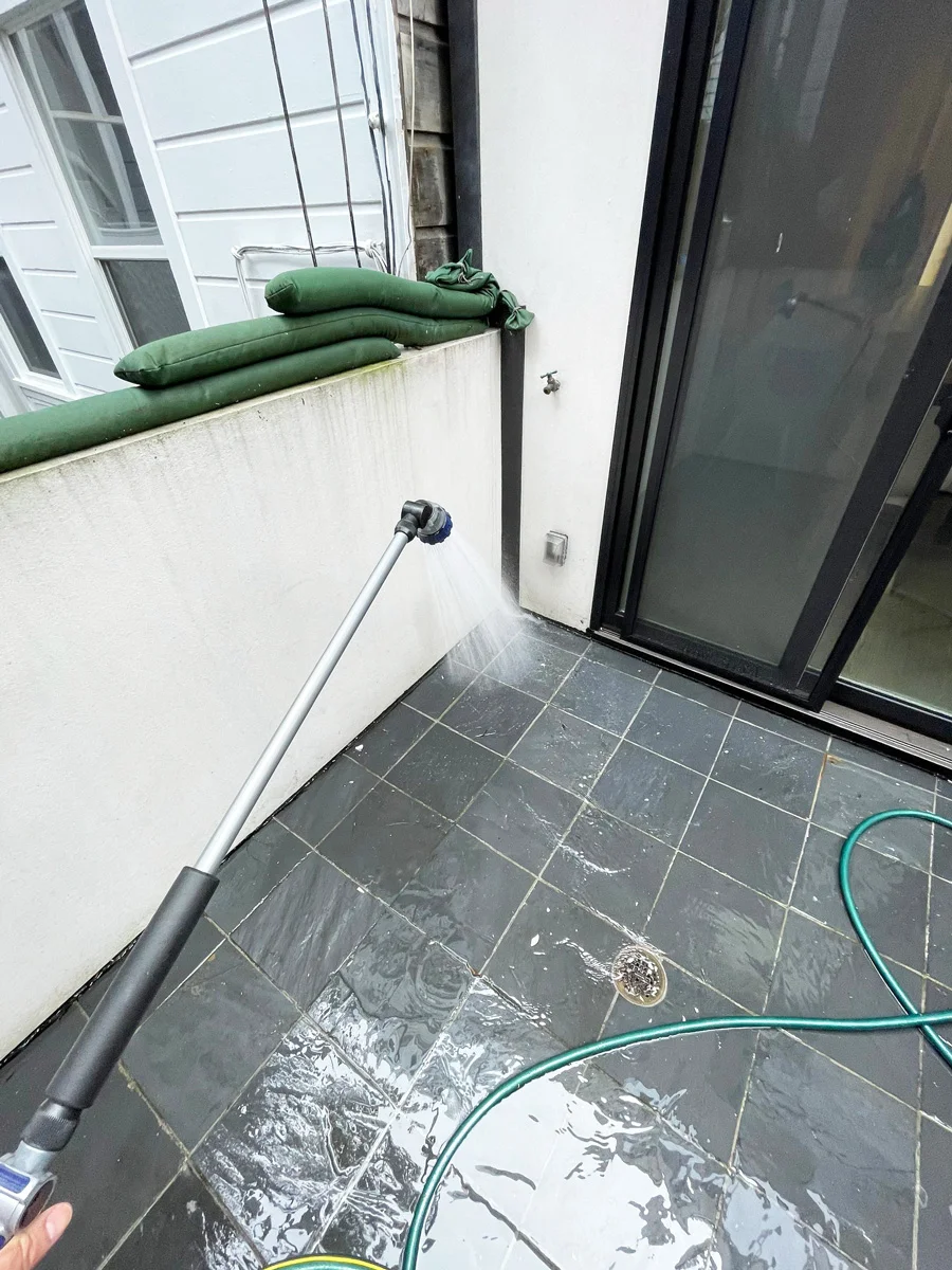 Hose used for a water test on an exterior tiled balcony — San Francisco, CA