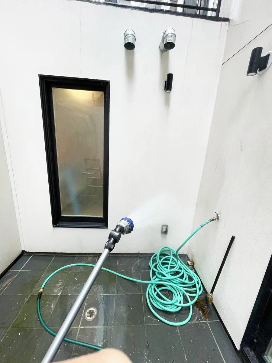 Hose and spray nozzle during an exterior leak test — San Francisco, CA