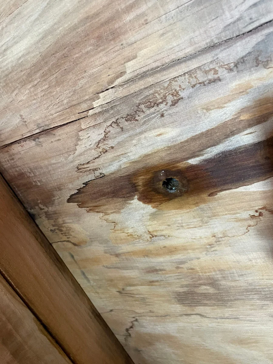 Water-stained wooden decking around a small opening — San Francisco, CA