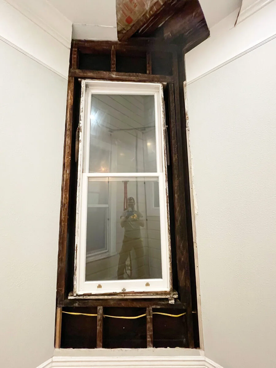 Window surrounded by exposed wall framing after demolition — San Francisco, CA