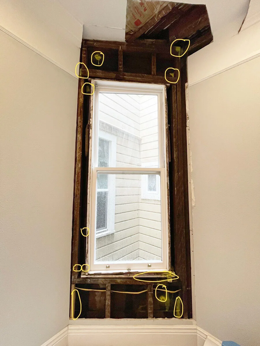 Marked areas around exposed window framing during leak investigation — San Francisco, CA