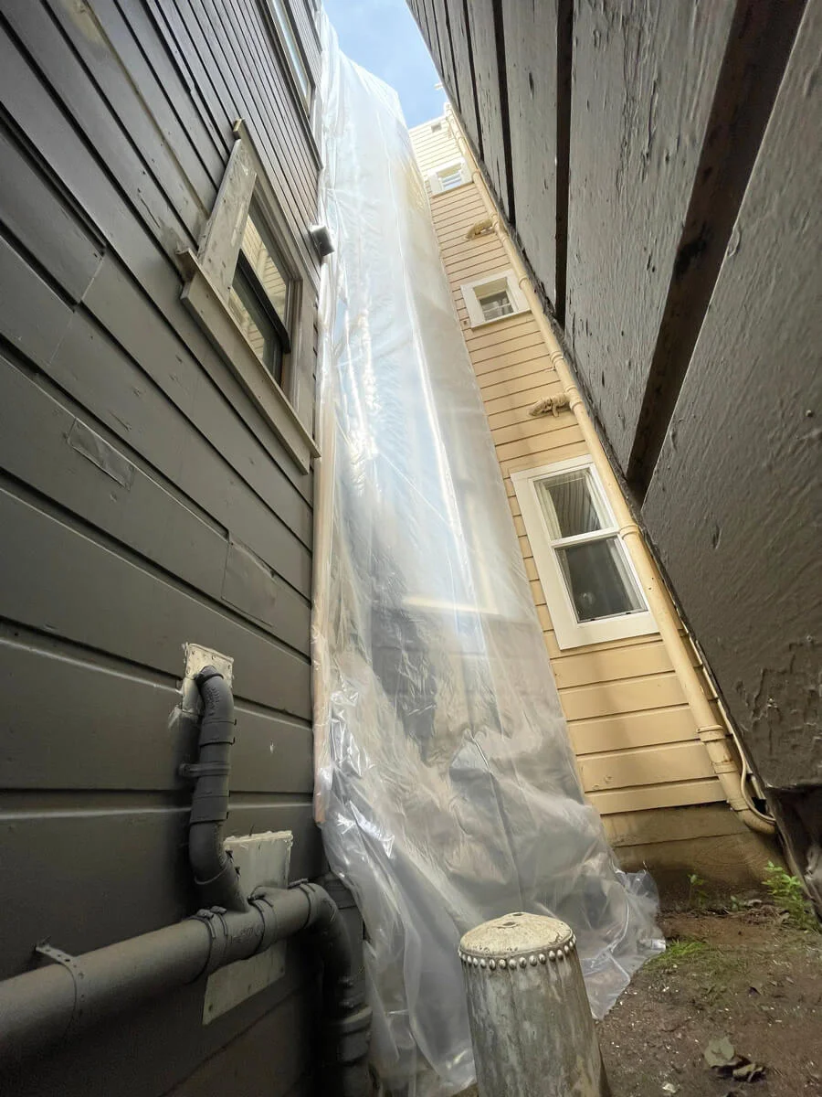 Exterior wall covered with protective plastic sheeting — San Francisco, CA