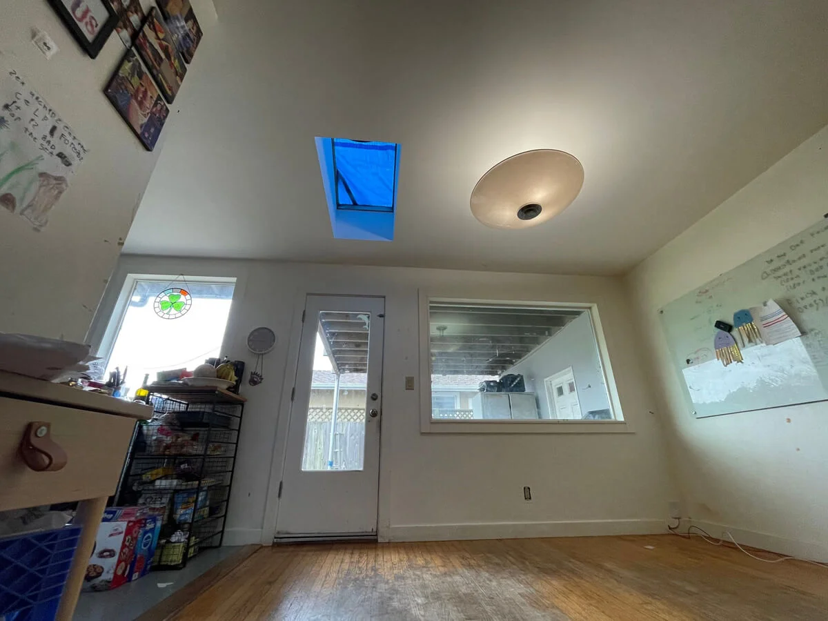 Room with a skylight before water-damage repairs — Pacifica, CA