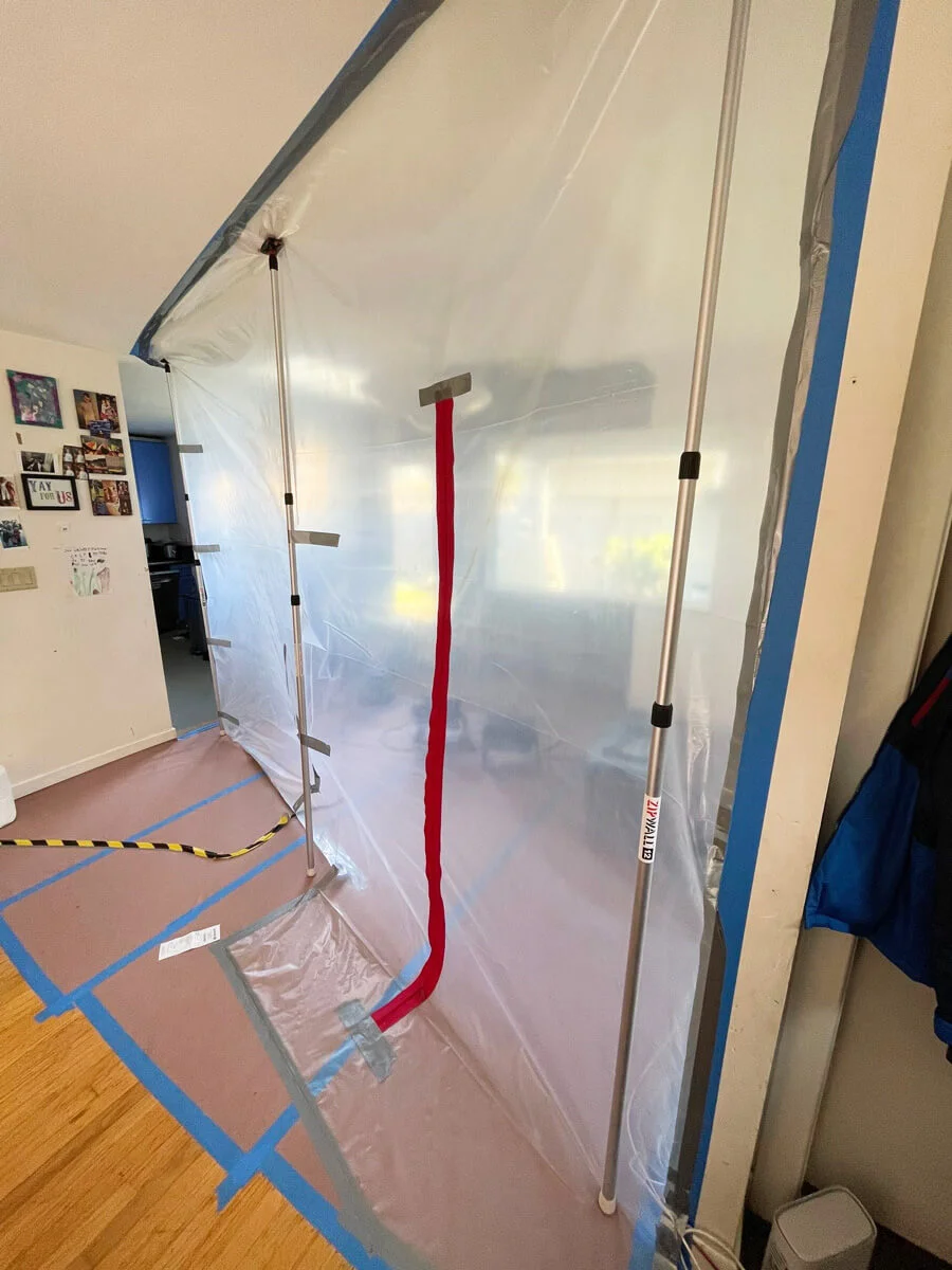 Plastic containment with a red zippered entrance — Pacifica, CA