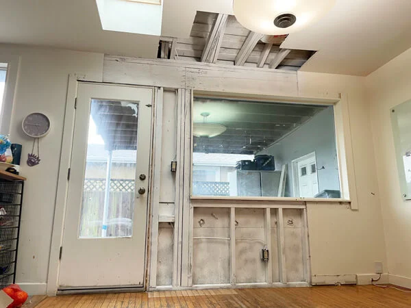 Room with exposed wall and ceiling framing beside windows — Pacifica, CA