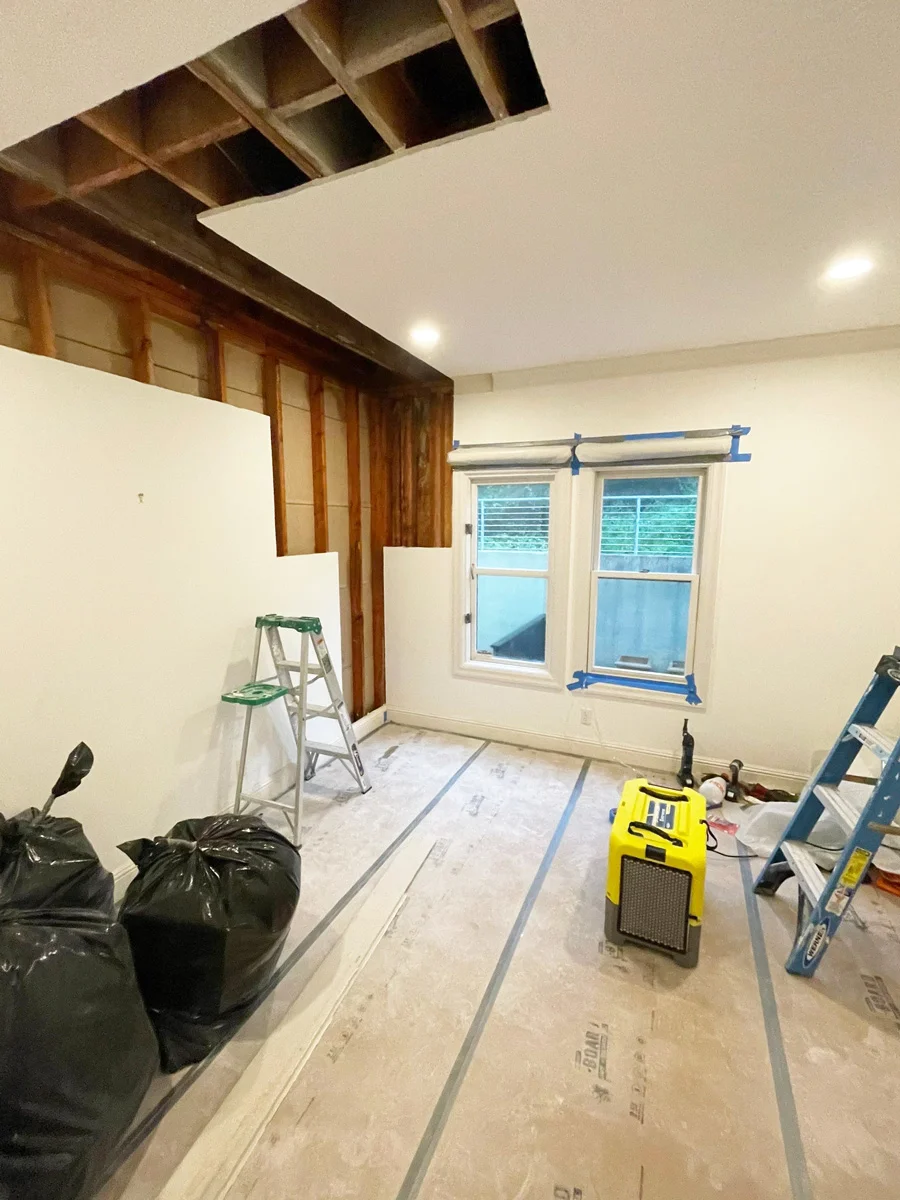 Exposed wall and ceiling framing during water-damage repairs — San Francisco, CA