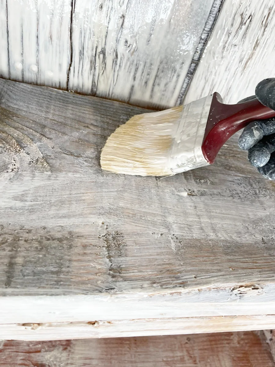 Brush applying a white coating to wood framing — San Francisco, CA
