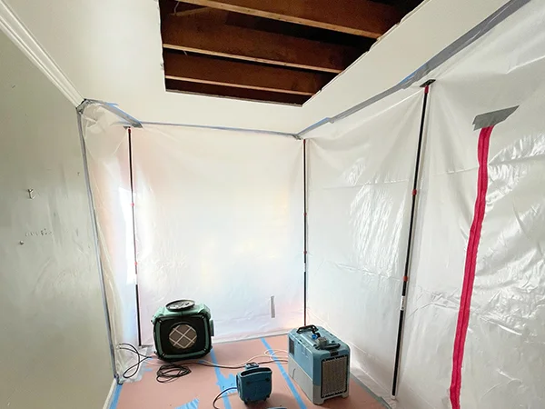 Air movers inside a plastic-walled containment area — Oakland, CA