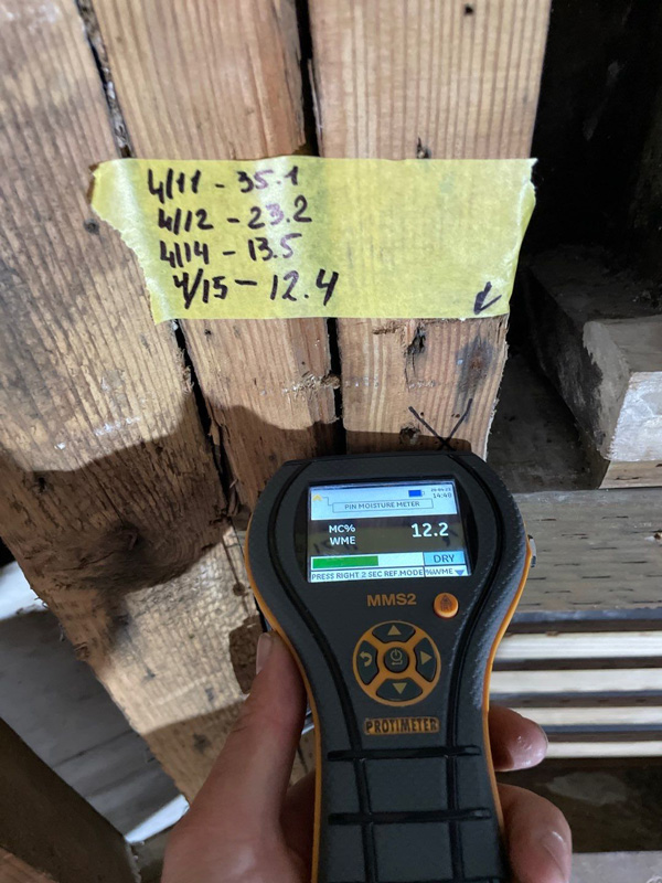 Moisture meter beside recorded readings on a wall stud — San Francisco, CA
