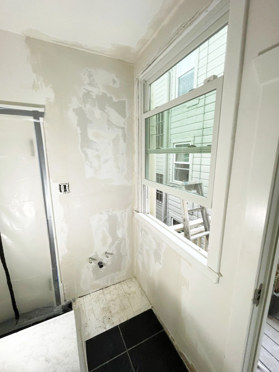 Bathroom wall patched around a window during reconstruction — San Francisco, CA