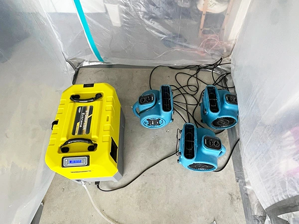 Dehumidifier and air movers inside a plastic containment area — San Mateo, CA